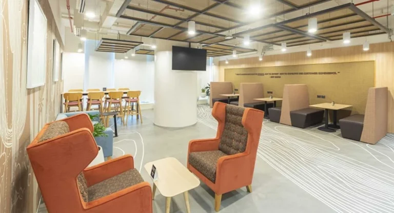 a luxury waiting room with sofa and table chairs for sitting